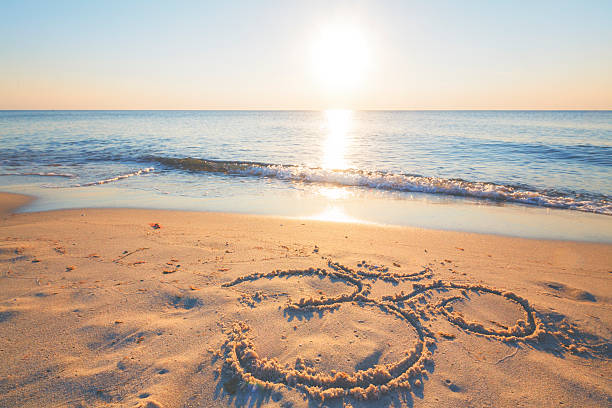 istock Om symbol in the sand by the ocean 484828632