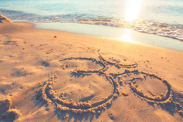 istock Om symbol in the sand by the ocean 484828636