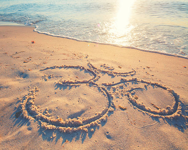 istock Om symbol in the sand by the ocean 484828640