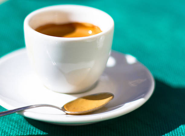 istock Espresso with Spoon in White Cup and Saucer; Green Background 484829736