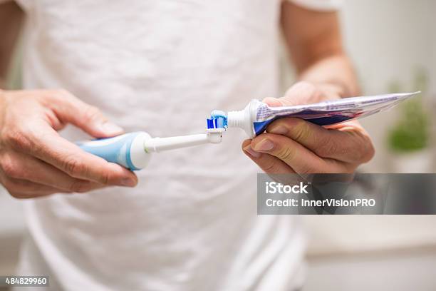 Always Use Gum Protective Toothpaste Stock Photo - Download Image Now - Electric Toothbrush, Men, Only Men