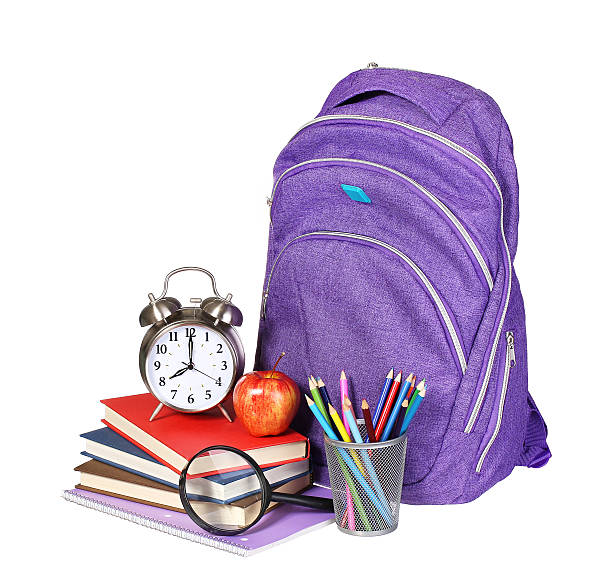 istock Books, apple, backpack, alarm clock and pencils isolated on white 484830118