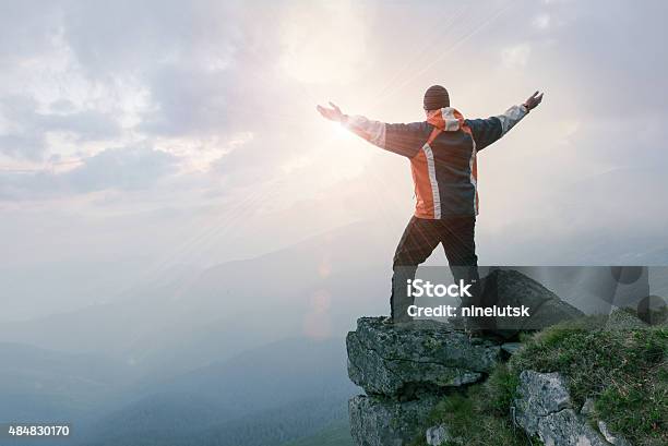 Man Standing On The Rock In The Mountains Stock Photo - Download Image Now - 2015, Achievement, Adult