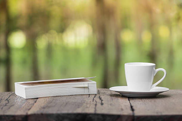 istock relaxation corner with coffee cup and book , sunlight  forest background 484830442