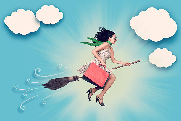 Happy woman on the broom is flying in the sky after shopping.