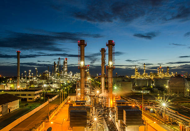 Oil refinery Oil refinery at twilight greenpeace stock pictures, royalty-free photos & images