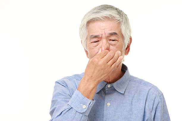 istock senior Japanese man holding his nose 484834470