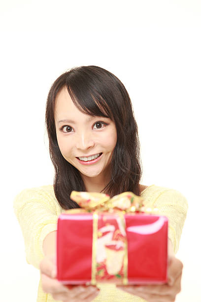 istock young Japanese woman offering a gift 484834738