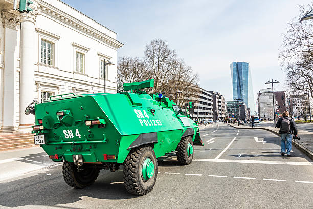 Frankfurt, Germany - March 18, 2015: police is equiped with water guns against people demonstrate at EZB  in Frankfurt, Germany. 30 tsd. people join the demo.