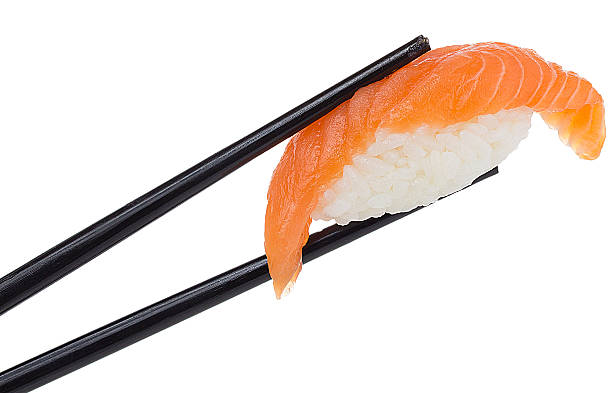 istock Salmon sushi nigiri in chopsticks isolated on white background 484835762