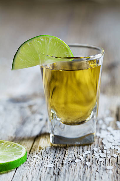 istock Tequila shot with lime and sea salt on rustic board 484836036