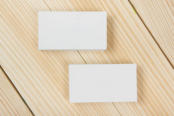 istock Blank white business cards on wood background 484836298
