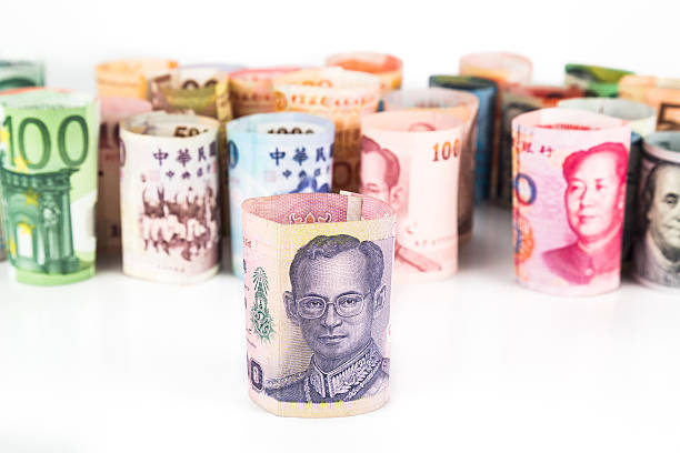 istock Pile of rolled-up currency notes with Thailand Baht in front 484838250