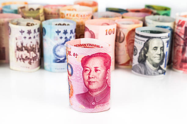 istock Rrolled-up currency notes with China Yuan Renminbi in front 484838328