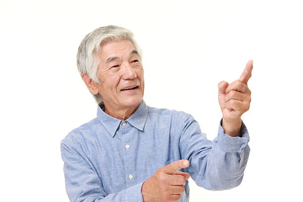 istock senior Japanese man presenting and showing something 484841338