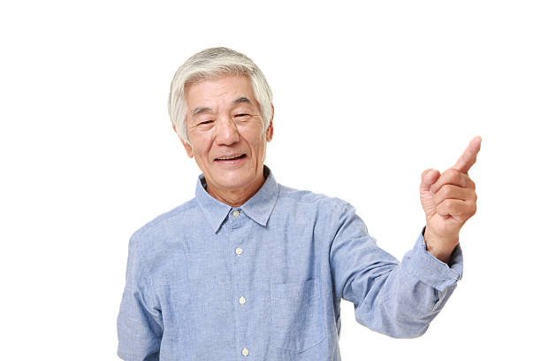 istock senior Japanese man presenting and showing something 484841342