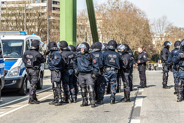 Frankfurt, Germany - June 1, 2013: Protestors and anti-riot police standing face to face at Blockupy 2013 demonstration in the city center of Frankfurt. Blockupy is a left-wing political network of several organizations. The name derives from its plan for a \