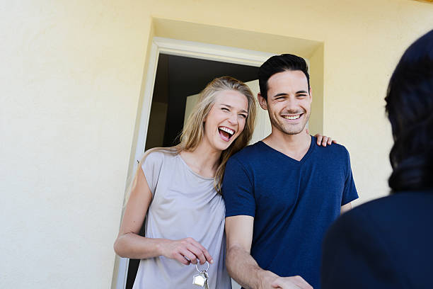 istock young couple with real estate agent getting new house key 484845430