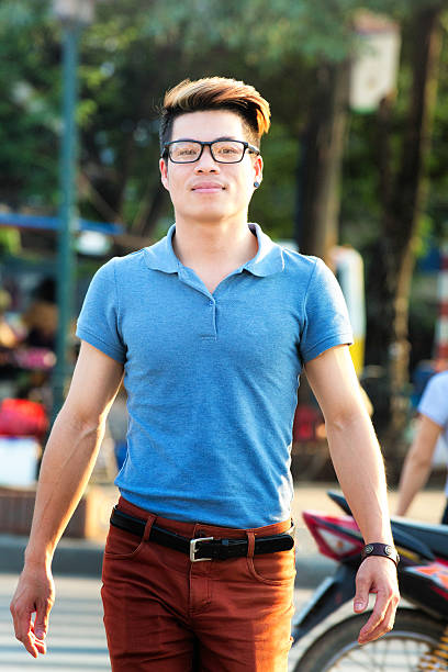 istock Confident young Vietnamese man crossing the street 484845592