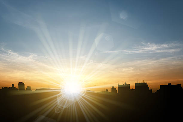 istock Sun flare over city silhouette 484850540