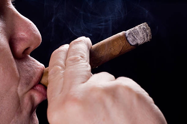 men smoking cigar stock photo