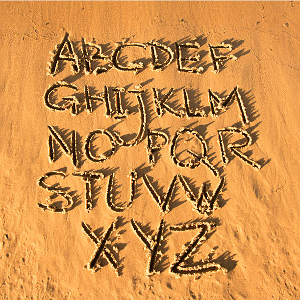 istock Latin alphabet handwriting on the sand. 484855428