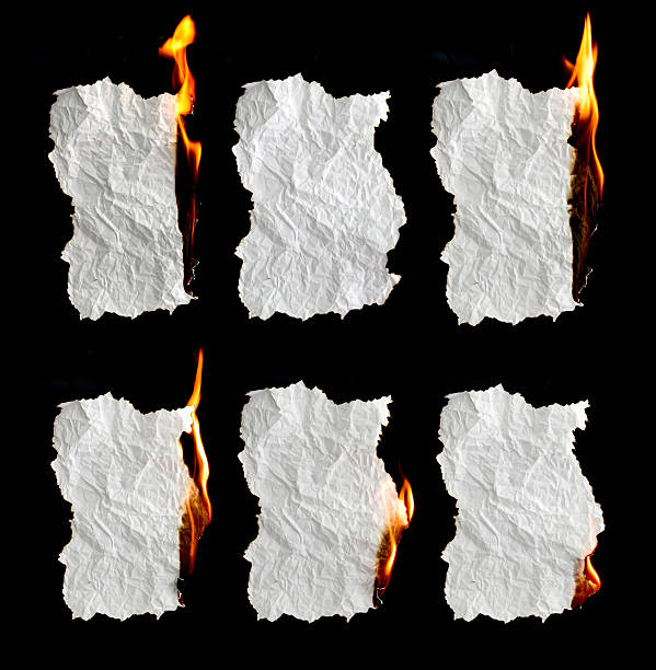 Photo of paper burning on black background