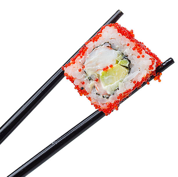 istock Sushi roll in chopsticks isolated on white background 484862266
