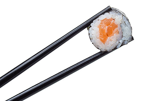 istock Sushi roll in chopsticks isolated on white background 484862288