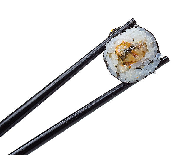 istock Sushi roll in chopsticks isolated on white background 484862300