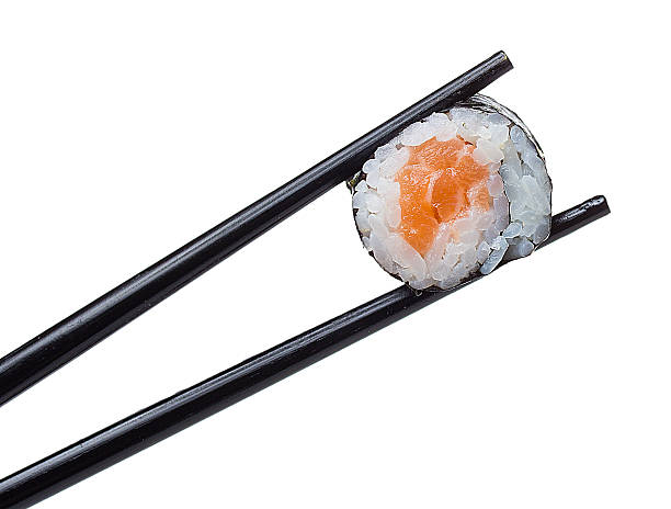 istock Sushi roll in chopsticks isolated on white background 484862350