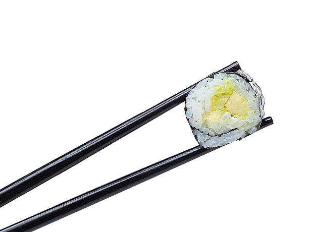 istock Sushi roll in chopsticks isolated on white background 484862358