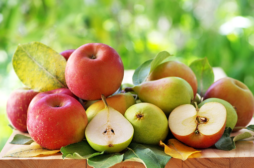 pears and apples  on a rustic wooden table