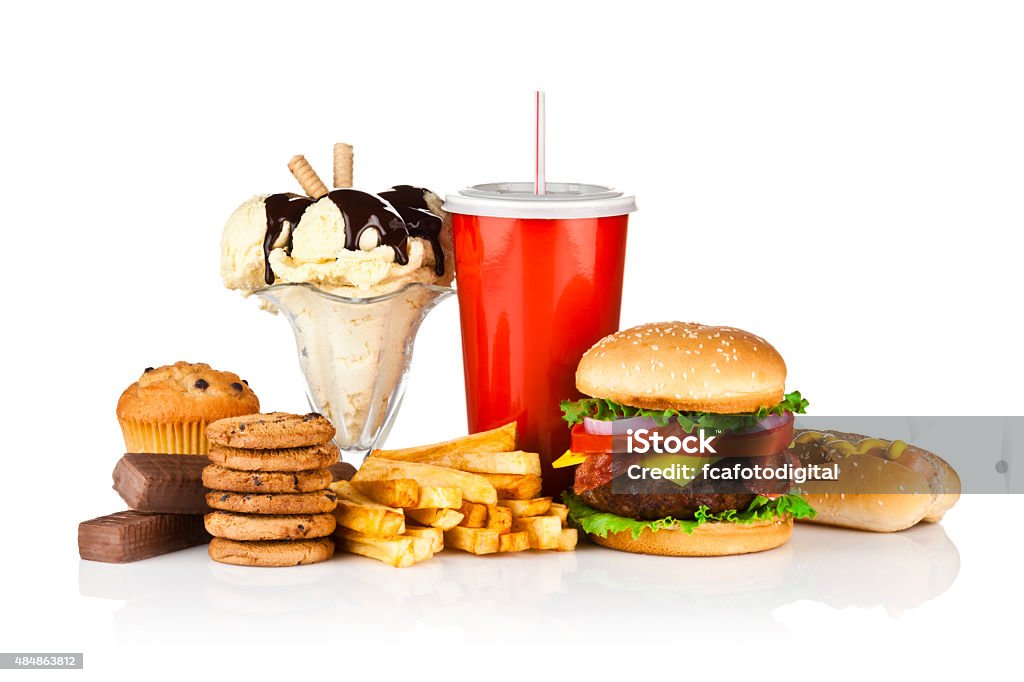 Unhealthy food isolated on white background Group of unhealthy food isolated on white background. The composition includes, candy bar, muffin, cookies, ice cream, french fries, a glass of soda, hamburger and a hot dog. This is an unhealthy food rich in carbohydrates, sugar and calories.  DSRL studio photo taken with Canon EOS 5D Mk II and Canon EF 70-200mm f/2.8L IS II USM Telephoto Zoom Lens Unhealthy Eating Stock Photo
