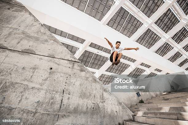Man Jumping Doing Urban Parkour Stock Photo - Download Image Now - Free Running, Jumping, City