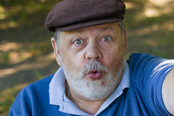 istock Senior man wondering and making first selfie in his life 484867104