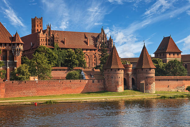 View of Malbork across river Nogat Malbork, Poland - August 08, 2015: The Castle of the Teutonic Order in Malbork is the largest castle in the world.  malbork photos stock pictures, royalty-free photos & images