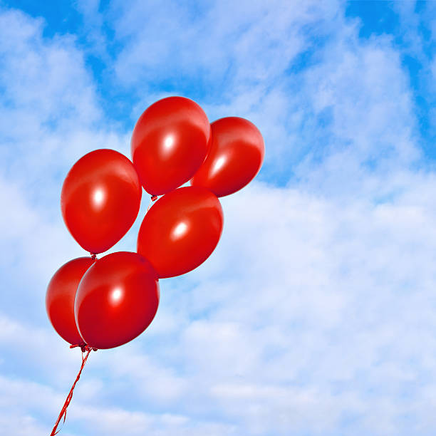 istock Red inflatable balloons on the sky background 484868488