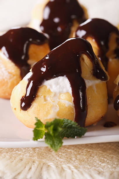 istock Fresh profiteroles withchocolate frosting macro. Vertical 484868618