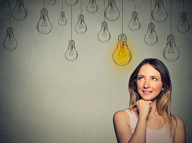 istock Big idea. Happy smart girl with solution lightbulb above head 484868652