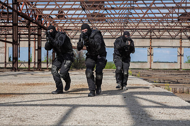 Special forces in action Special forces operators in black uniform in action spetsnaz stock pictures, royalty-free photos & images