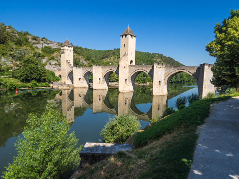 The Pont Valentre  is a 14th-century six-span fortified stone arch bridge crossing the Lot River to the west of Cahors, in France. It has become a symbol of the city.