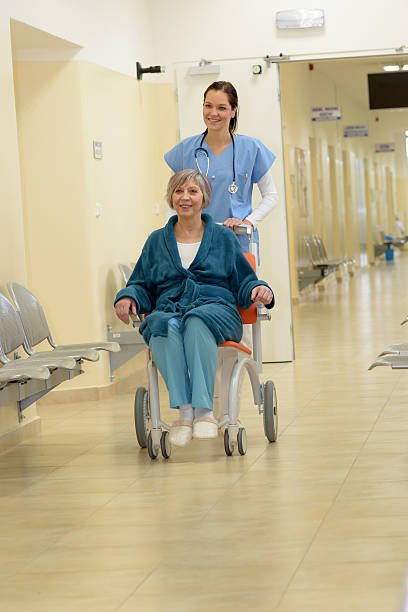istock Nurse pushing patient in wheelchair 484880418
