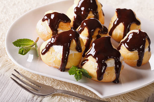 istock Delicious profiteroles with cream and chocolate glaze 484880984
