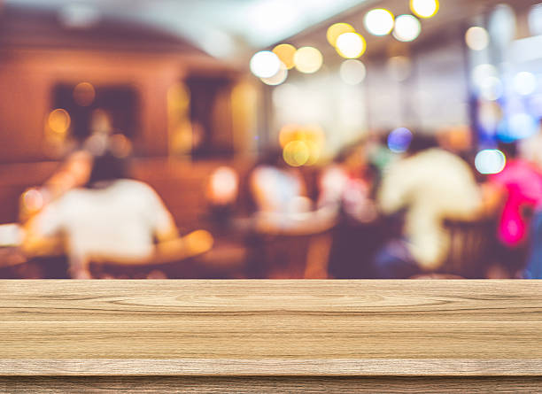 istock Empty wood table and blurred cafe light background. product disp 484883542