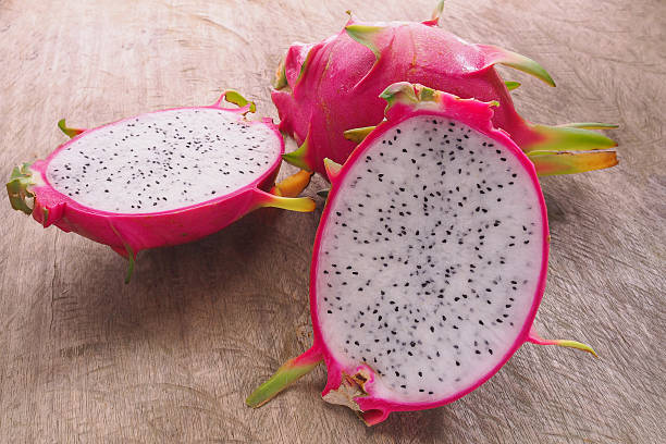 istock Dragon Fruit and some slice on old Wooden Table 484884152