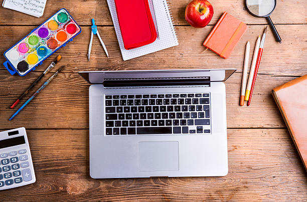 Back to school composition Desk with school supplies. Studio shot on wooden background. apple keyboard stock pictures, royalty-free photos & images