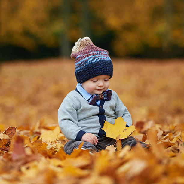istock cute little baby in autumn park 484889246