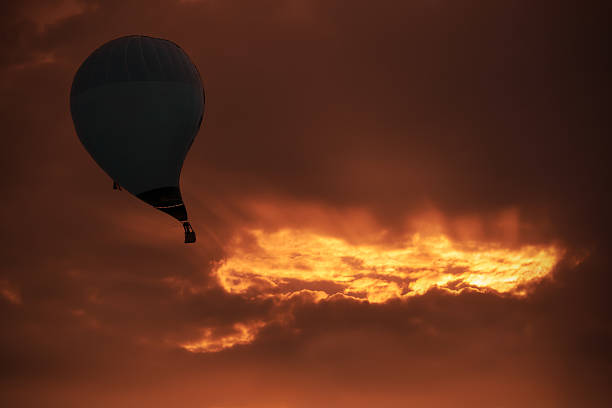 Hot air balloon sucked into black hole. Abstract work.