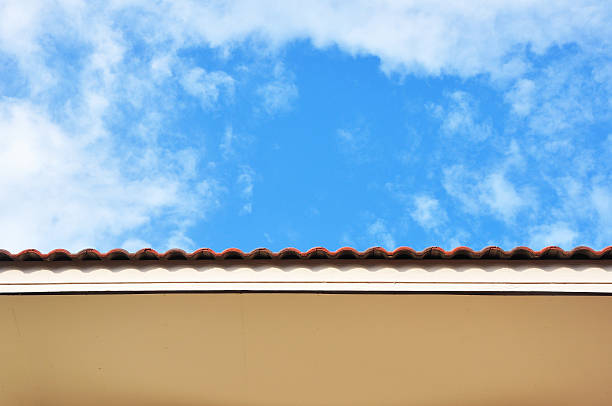 istock Tile house roof among bright sky 484893404